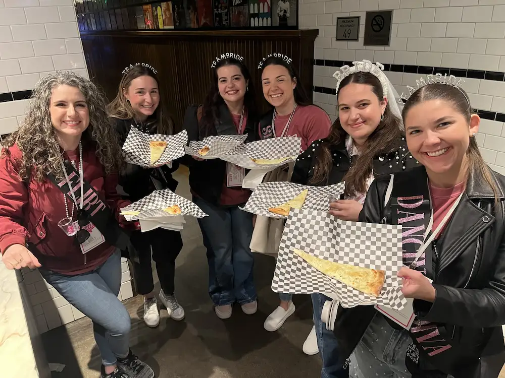 Bachelorette party enjoying pizza on a food tour