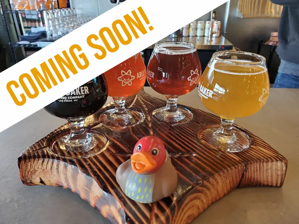A flight of craft beers on a wooden board