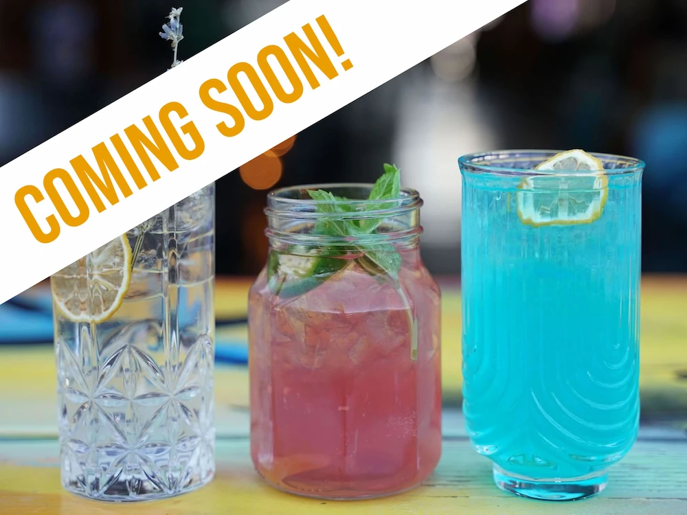 Colorful craft cocktails lined up on a bar